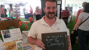 photo of TVT rider holding a chalk board saying I am Driven to be part of my community