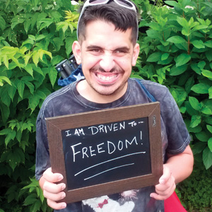 photo of TVT rider holding a chalk board saying I am Driven to freedom
