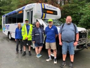 photo of bus drivers in front of a TVT bus